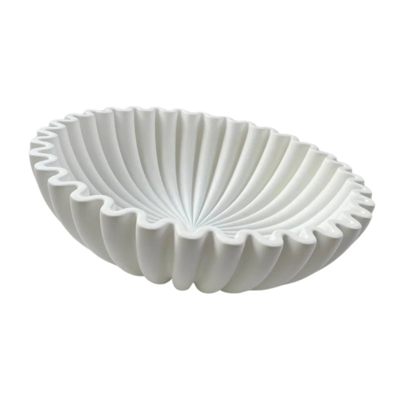 A white modern ruffle scalloped decorative bowl with deeply ribbed exterior.