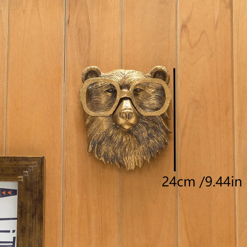 A brass deer head storage hook wall decor featuring a textured face and goggles mounted on a wooden panel.