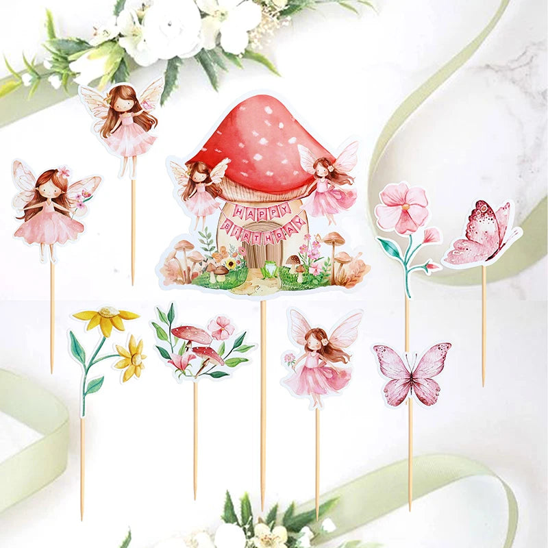 A set of fairy cupcake toppers featuring pink and white floral designs, butterflies, and a red mushroom house.