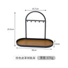 Black wrought iron desk organizer rack with a leather tray and hanging hooks