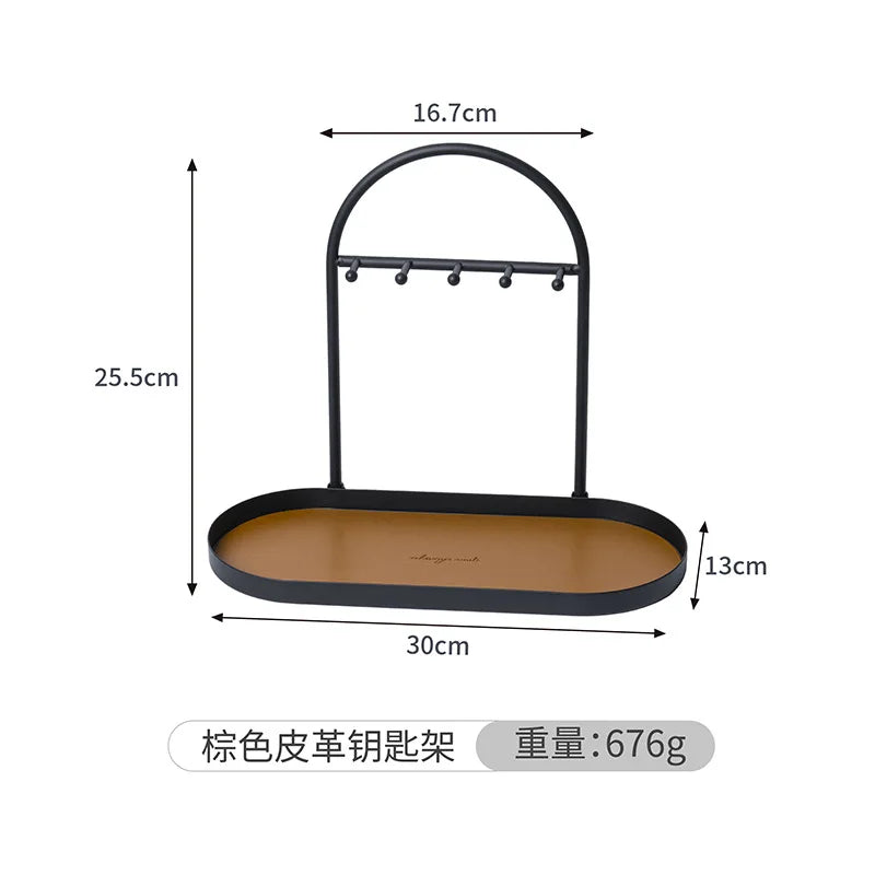 Black wrought iron desk organizer rack with a leather tray and hanging hooks