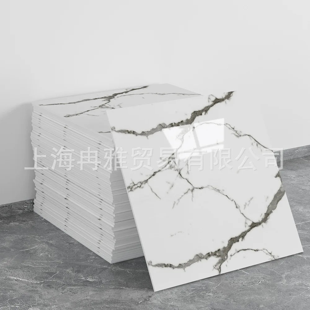 A stack of white faux marble tiles with gray veining is displayed next to a single tile.