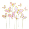 Pink and yellow paper butterfly cake toppers on thin sticks