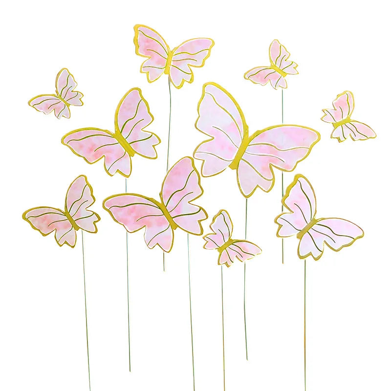 Pink and yellow paper butterfly cake toppers on thin sticks