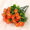 A bouquet of lifelike silk orange and yellow daisies with green leaves.