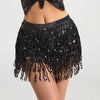 A black sequin hula dancer skirt with tassel belts worn by a model.