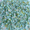 A close-up of a set of 50 light blue silk artificial flower heads with yellow stamens and pink accents.