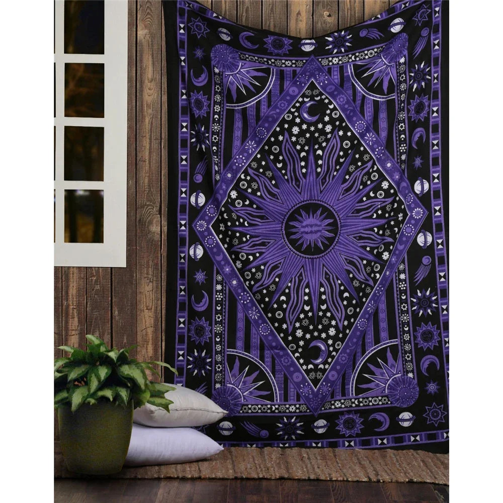 A dark purple and black bohemian mandala tapestry wall hanging displayed on a wooden surface.