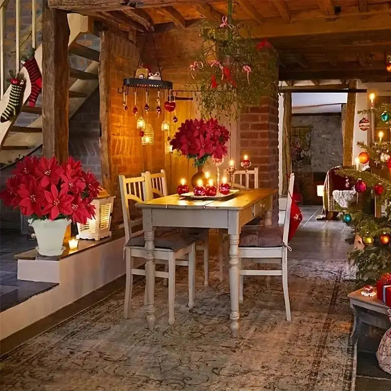 A rustic interior features a wooden dining table set for holiday decor with a bouquet of red poinsettias.