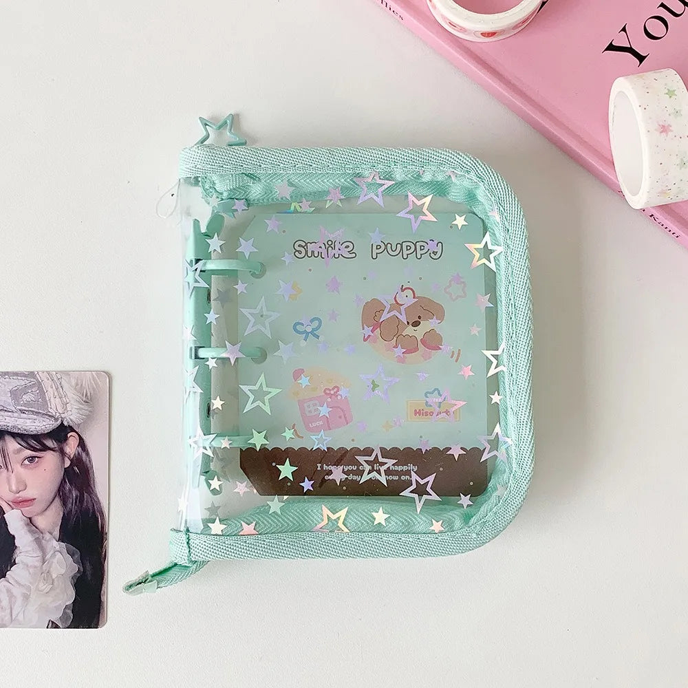 A mint green glitter star card binder is shown next to a photo and a pink notebook.