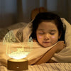 A child is resting with a 3D illusion acrylic LED night light illuminating a silhouette of a tree and a cat.