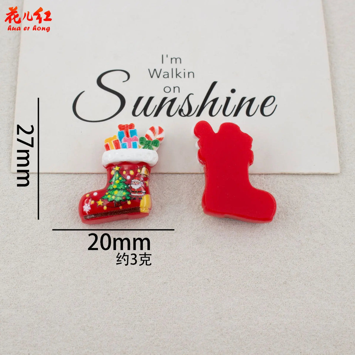 Red resin boots and a Christmas tree cabochon displayed on a white background.