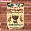 Vintage tin sign with Spanish text welcoming guests to a backyard patio for relaxing and grilling.