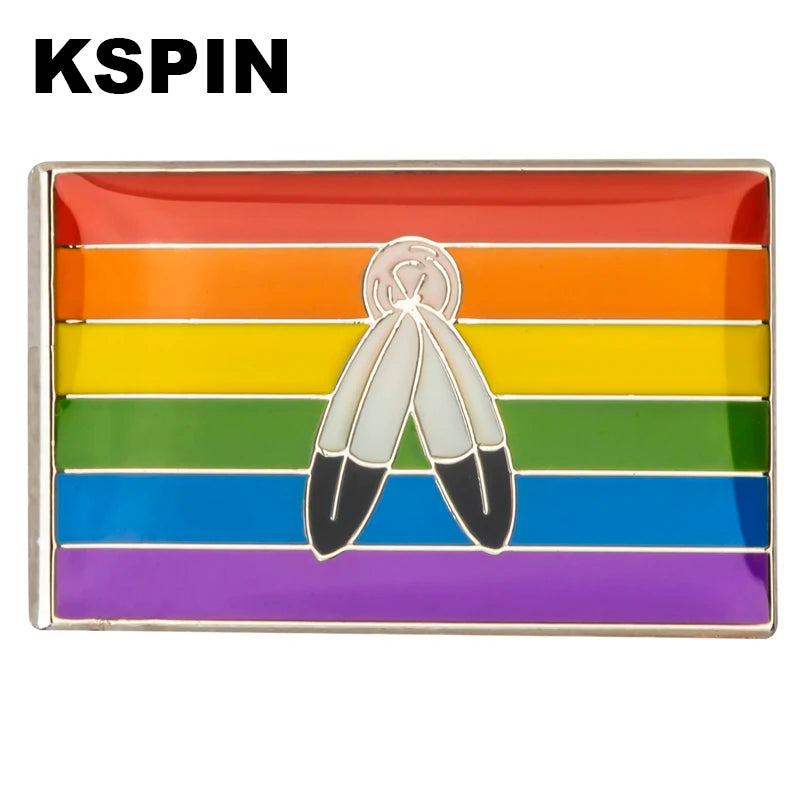 A lapel pin featuring a rainbow flag design with two butterfly shapes in the center.