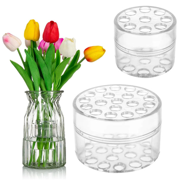 A glass vase holds tulips, and two clear plastic spiral stem holders are shown.
