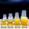 A display of eight clear plastic tasting cups filled with yellow liquid, labeled for 20 to 80 yuan pricing.
