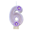 A purple sparkling number six candle decorated with small purple flowers.