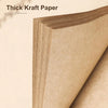 A close-up view of thick kraft paper sheets bound together, showing the texture and thickness of the paper.