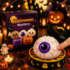 A Halloween simulation baozi ghost dumpling toy displayed with pumpkins, candles, and spooky decorations.