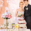 A wedding photo featuring a bride and groom, with a crystal flower centerpiece stand and candle holder on the table.