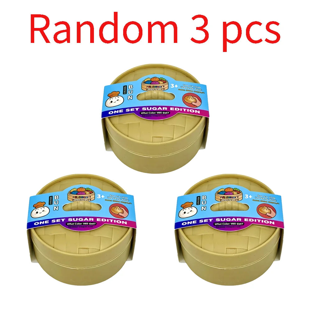 Three yellow plastic containers of a colorful simulated dumpling squishy toy