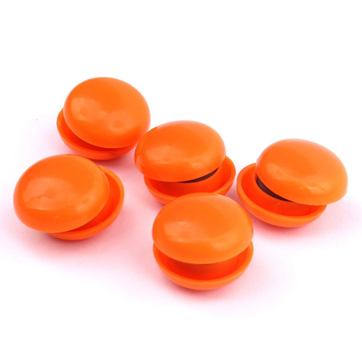 A set of ten round, orange refrigerator magnets for photos and notes.