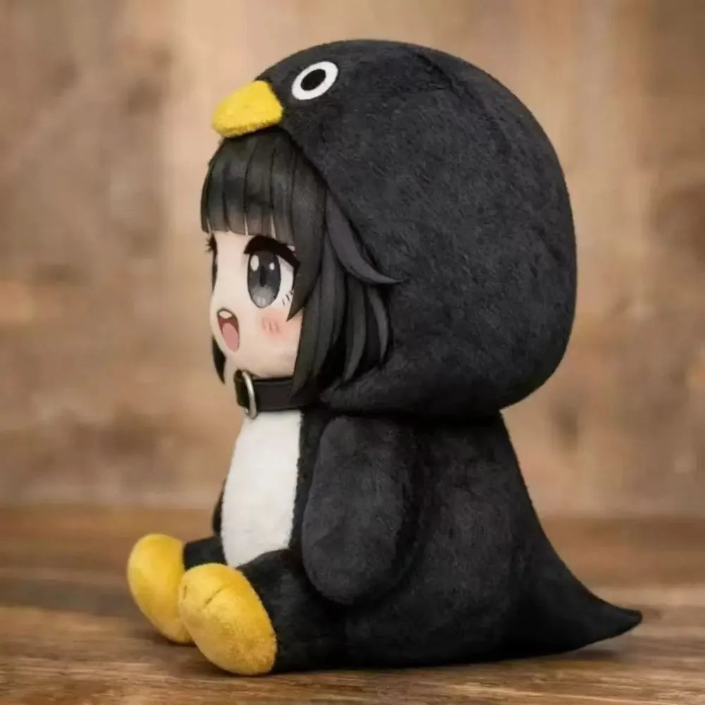 A cute kawaii penguin plush doll with black and white fur and yellow feet sitting on a wooden surface.