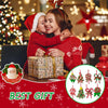 A woman in a red sweater is hugging a child while sitting next to a wrapped gift and Christmas lights.