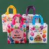 A set of colorful reusable happy birthday gift bags in pink, yellow, purple, and blue.