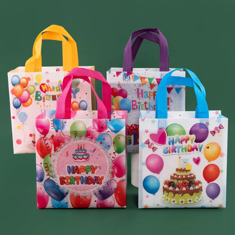 A set of colorful reusable happy birthday gift bags in pink, yellow, purple, and blue.
