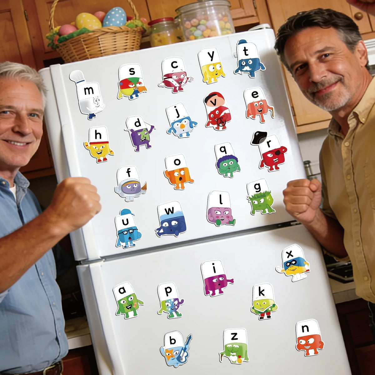 A collection of 26 colorful popsicle alphabet magnets displayed on a white magnetic board.