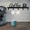 A black wall-mounted coffee mug rack with heart hooks is displayed against a light gray brick background.
