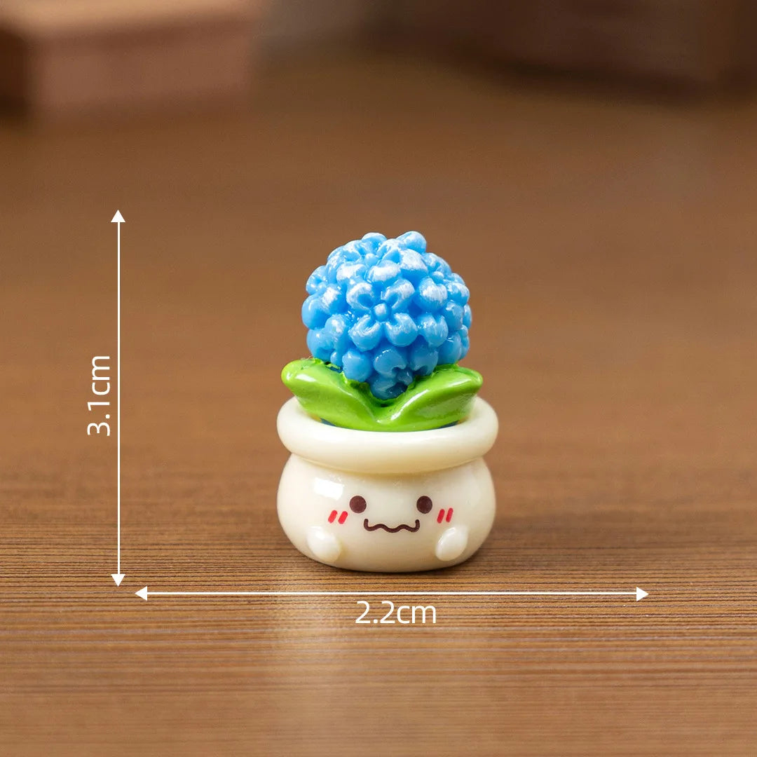 A small white ceramic pot with a bright blue, textured flower on top, used as a craft or dollhouse decoration.