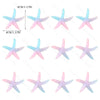 A set of mermaid tail cake toppers featuring sea star and seashell decorations in pink and light blue.