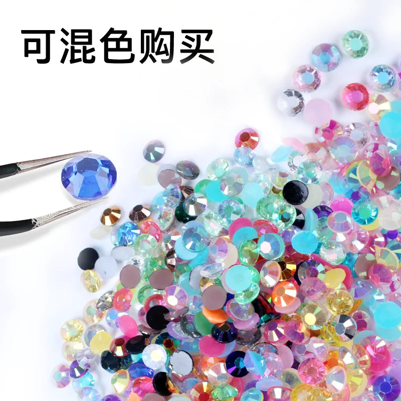 A pile of colorful resin rhinestones in various shades including blue, pink, green, and gold.