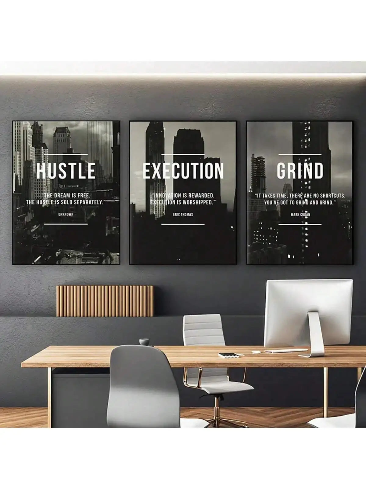 A set of three framed wall art prints featuring motivational text Hustle Execution and Grind displayed above a wooden desk.