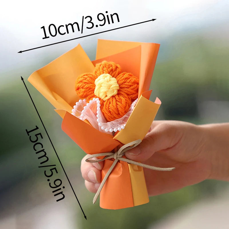 Handmade crochet flower bouquet in orange and yellow paper with a small orange flower inside