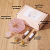 A box containing a natural crystal dropper candle set for Reiki and meditation, shown next to the crystals and wooden applica