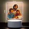 A 3D LED night light featuring a painting of a father and two children, illuminated with soft light.
