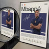 A framed poster featuring a portrait of Kylian Mbappé with a signature and statistics.