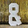 A large white marquee light-up letter for party decor is displayed against a shimmering gold curtain backdrop.