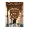 An interior view of an Islamic mosque corridor with arched ceilings and columns, featuring intricate geometric patterns.