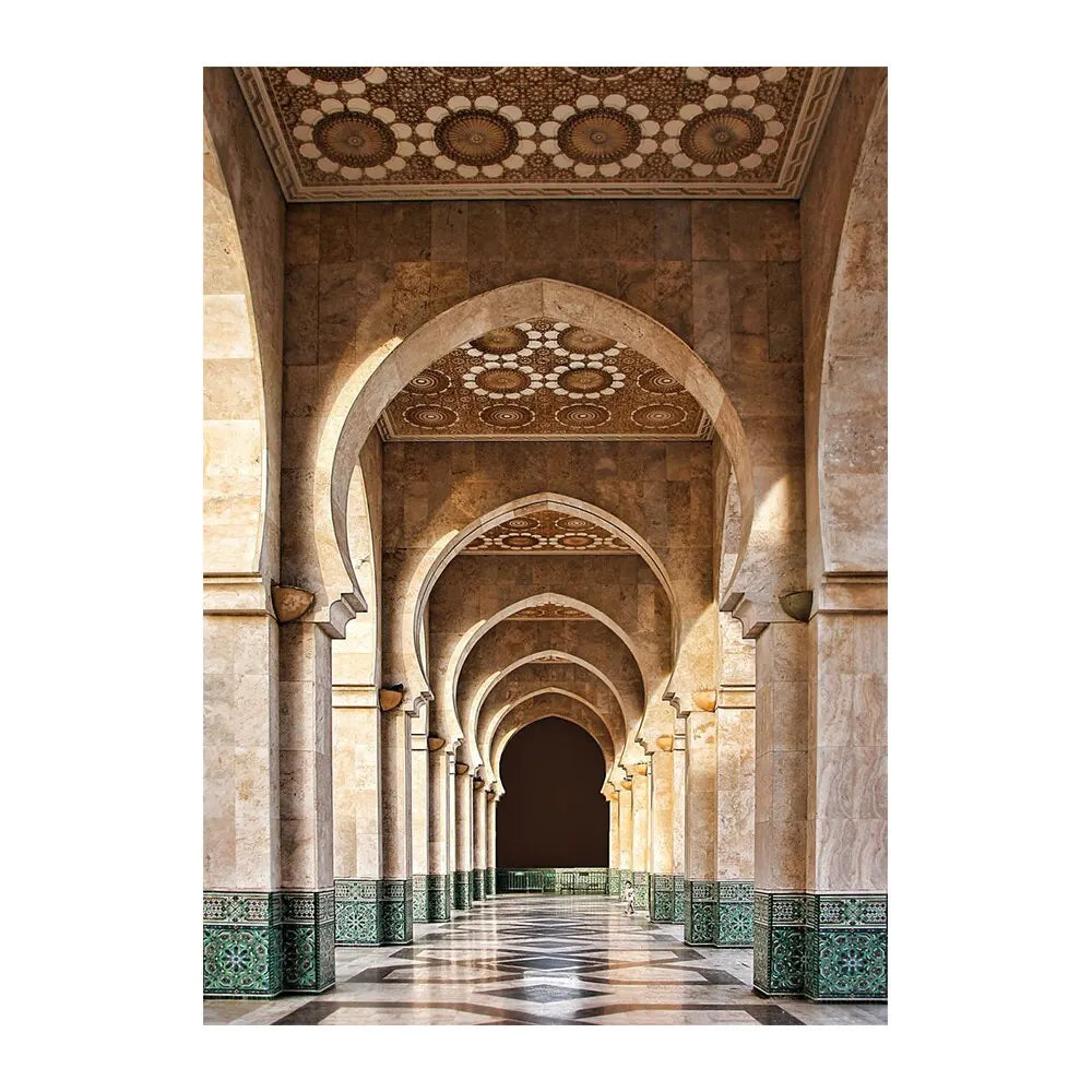 An interior view of an Islamic mosque corridor with arched ceilings and columns, featuring intricate geometric patterns.