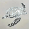 Silver metal sea turtle wall art featuring intricate cutout design for coastal beach decor