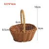 A brown handwoven rattan storage basket with a handle, shown from above.