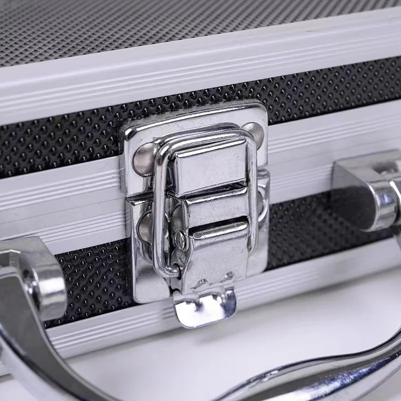 A silver aluminum tattoo machine storage box with reinforced corners and a metal latch is shown.