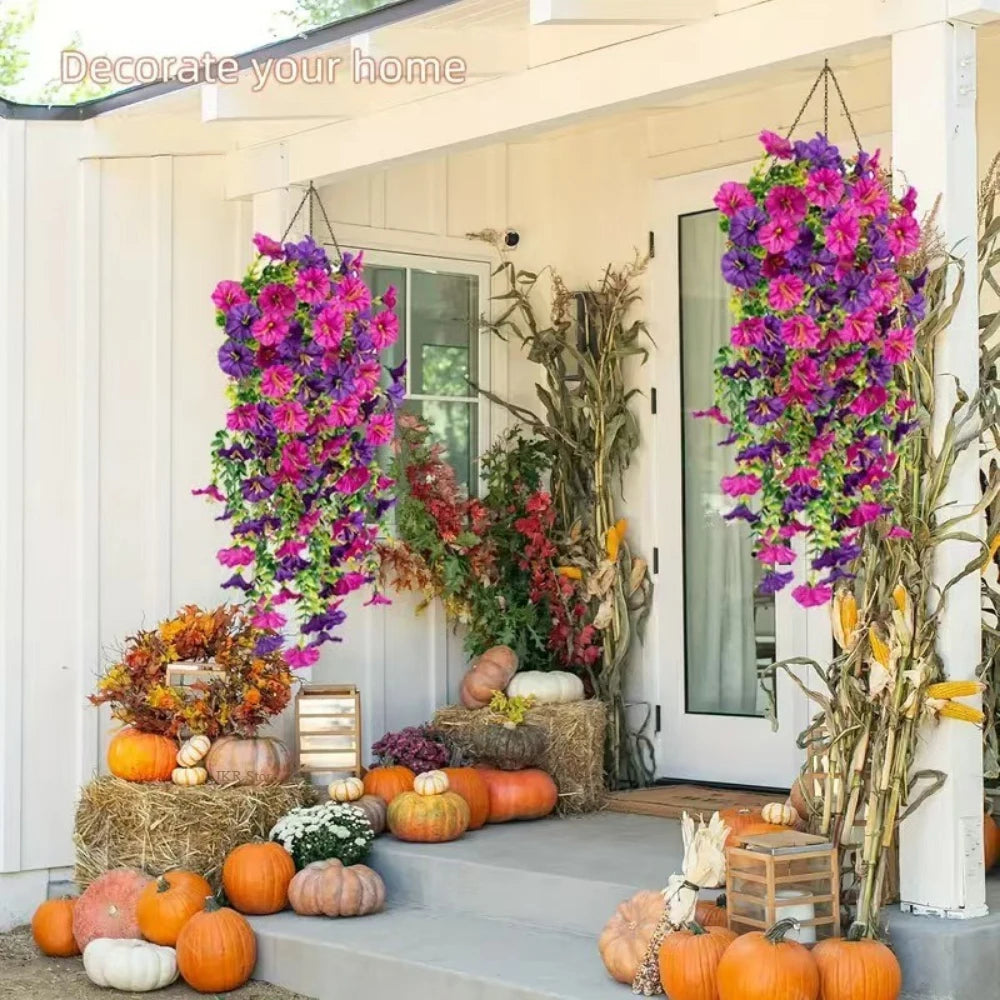 A vibrant purple and pink artificial morning glory and eucalyptus garland decorating a porch entrance with pumpkins.