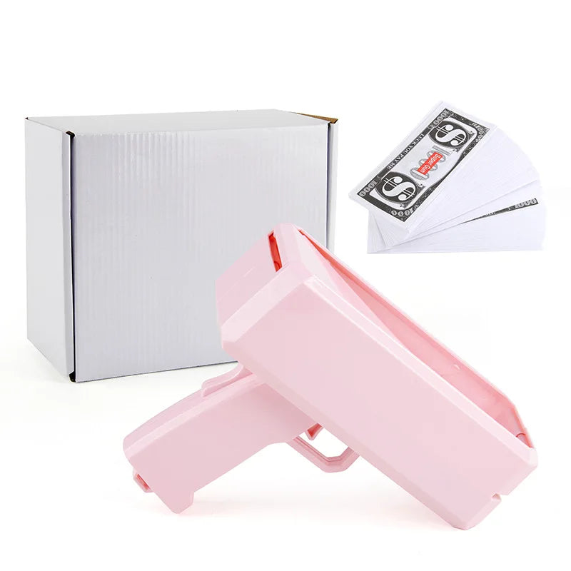 A pink funny money shooter toy box and several stacks of fake money bills.