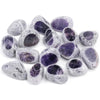 A collection of tumbled natural crystals including clear quartz, rose quartz, and amethyst in various shades of purple and gr