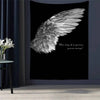 A black tapestry wall hanging featuring a white feathered angel wing design and the quote One day I'm gonna grow wings
